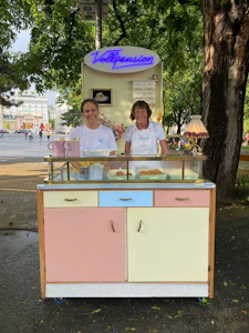 Two generation team of baking grandma and young colleague working at the Buchtelmobil